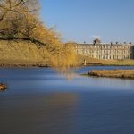 View across the lake to the west front of Petworth House in the Sussex parkland