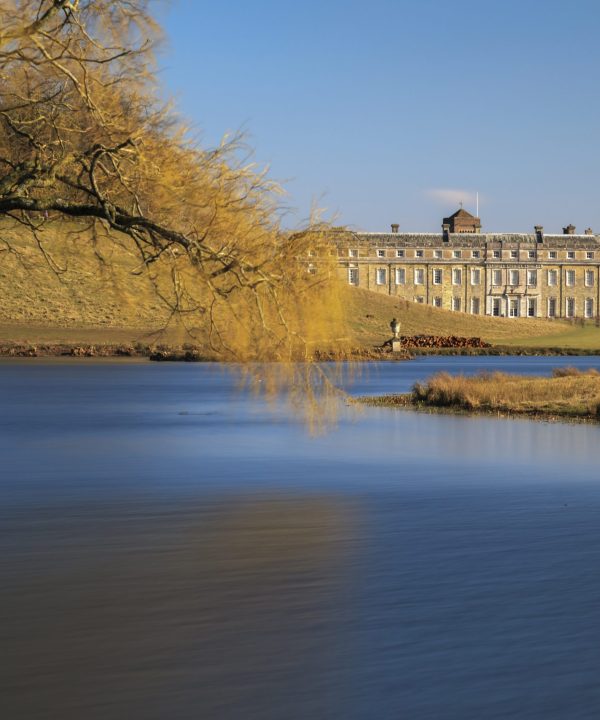View across the lake to the west front of Petworth House in the Sussex parkland