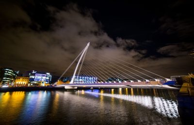 Night view of the illuminated bridge over the river in Pittsburgh.
