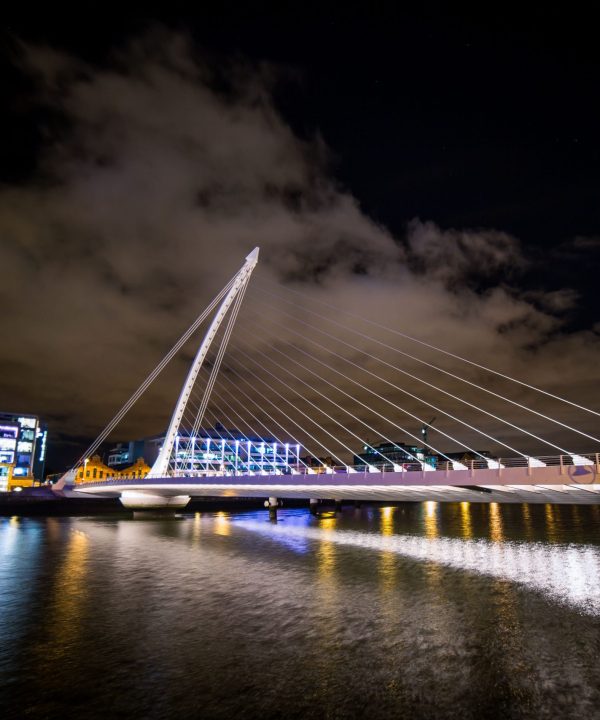 Night view of the illuminated bridge over the river in Pittsburgh.