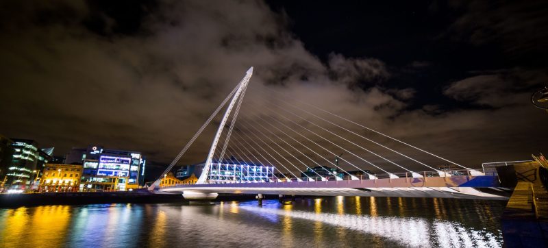 Night view of the illuminated bridge over the river in Pittsburgh.
